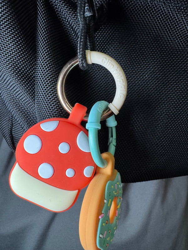 Mushroom charm on a backpack with Clip Huggie